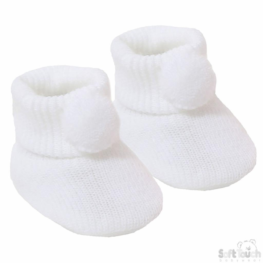 A pair of white baby booties with pom pom detail.