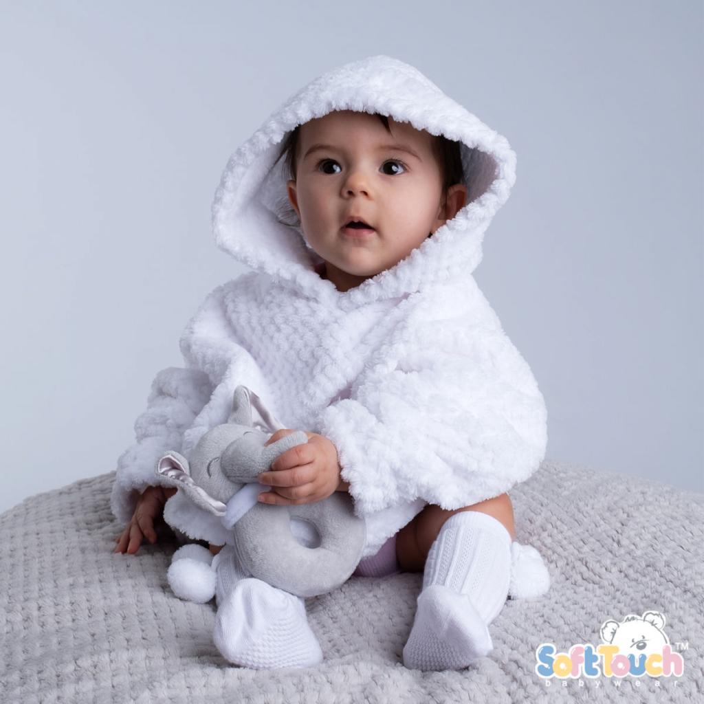 A baby wearing a white waffle hoodie with a hood pocket, paired with white pants, sitting and holding a gray toy.